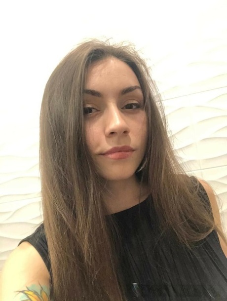 Brunette American takes selfies of her medium tits and round booty
