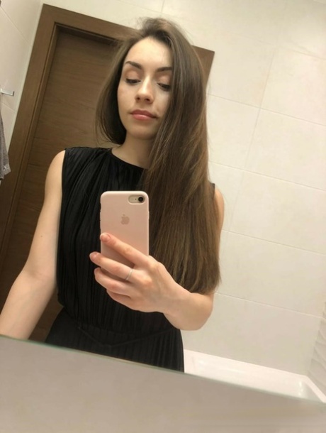 Brunette American takes selfies of her medium tits and round booty