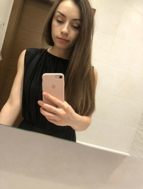 Brunette American takes selfies of her medium tits and round booty
