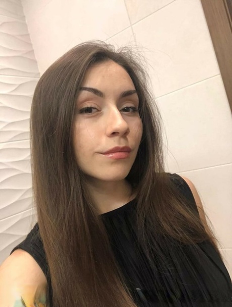 Brunette American takes selfies of her medium tits and round booty
