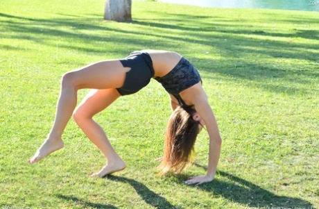 Teenage hottie in sexy outfit Zoe doing exercise outdoors by the water