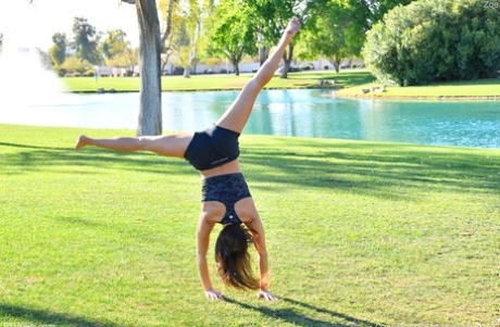 Teenage hottie in sexy outfit Zoe doing exercise outdoors by the water