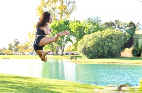 Teenage hottie in sexy outfit Zoe doing exercise outdoors by the water