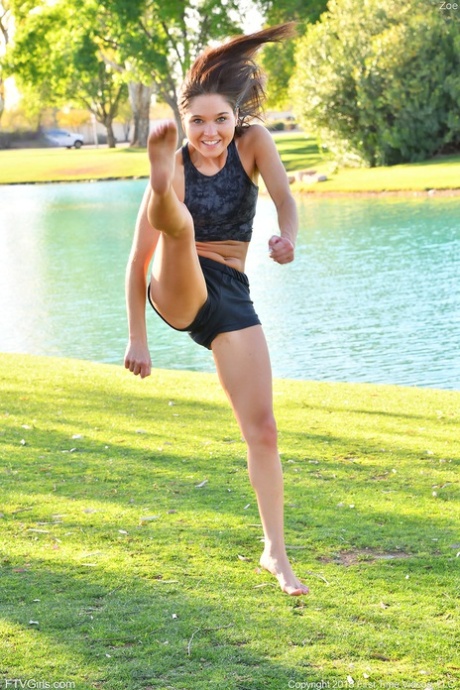 Teenage hottie in sexy outfit Zoe doing exercise outdoors by the water