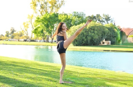 Teenage hottie in sexy outfit Zoe doing exercise outdoors by the water