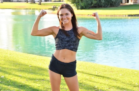 Teenage hottie in sexy outfit Zoe doing exercise outdoors by the water