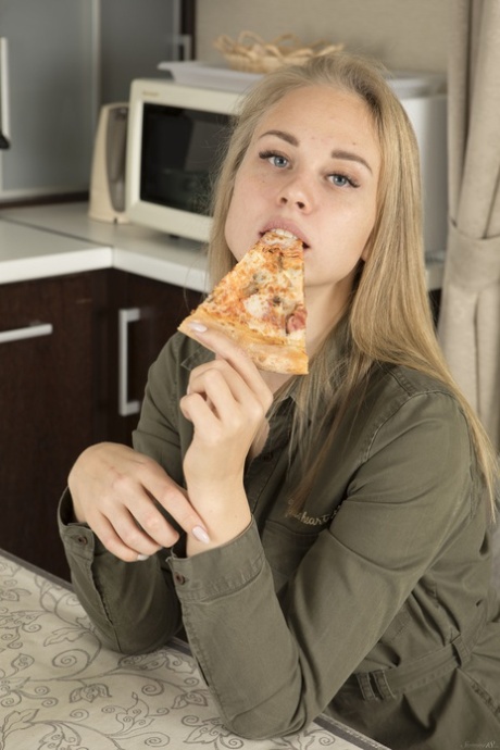 Sweet teen Orika eats a pizza and exposes her wonderful love holes