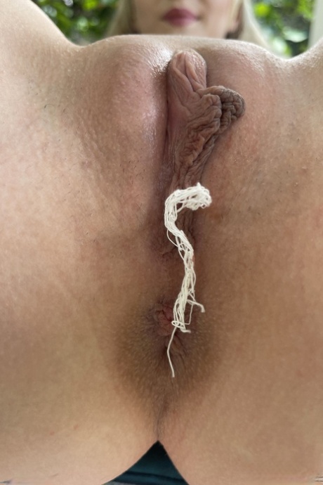 Petite teen Cecelia Taylor spreads her pussy up close with her tampon on