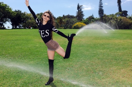 Slim teen Irene Rouse flashes her ass while showing her flexibility in public
