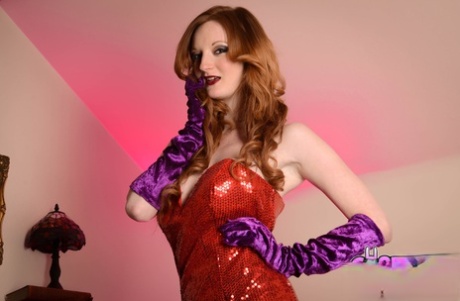 Glamorous ginger Zara Du Rose posing in her long red dress & heels