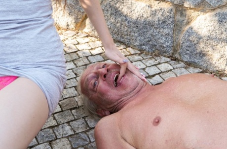 Skinny teen Nela Decker gives a kinky grandpa a CFNM hanjob outdoors