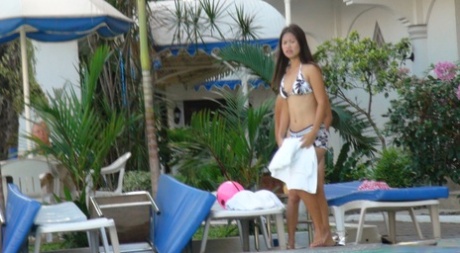 Asian babe Anne Agustin and her lesbian friend undress and pose on a bed