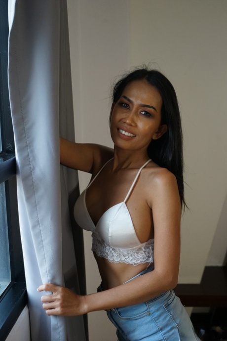 Sweet Asian babe Noki shows off her firm fake tits and gets banged hard