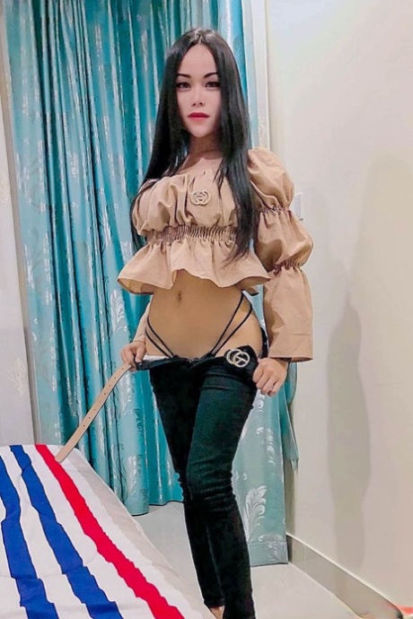 Sexy Asian shemale shows off her perfect body in pretty outfits
