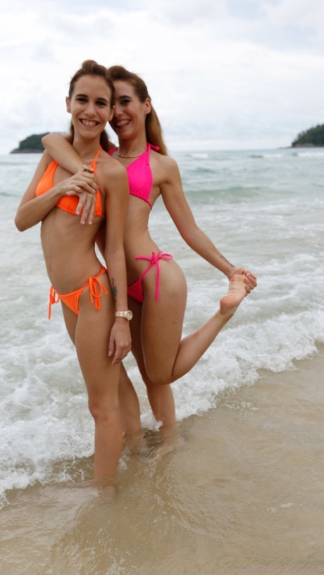 Sexy babes Kitty & Nikky show off their petite bodies in bikinis at the beach