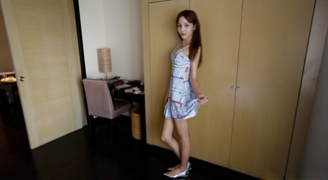 Beautiful Asian shemale flashes her perfect tits in a sexy dress