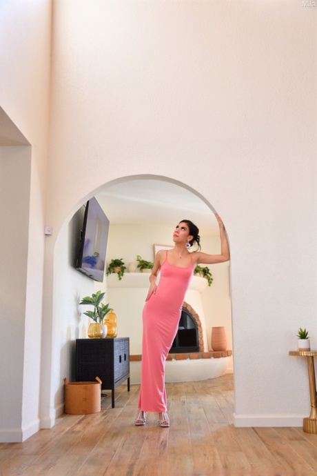 Naughty amateur babe Mila shows her cunt and poses in a tight pink dress
