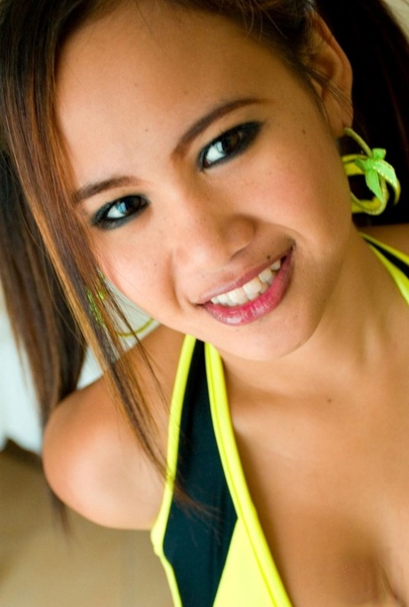Sweet Asian babe Beer shows her suckable boobs and poses nude on a chair