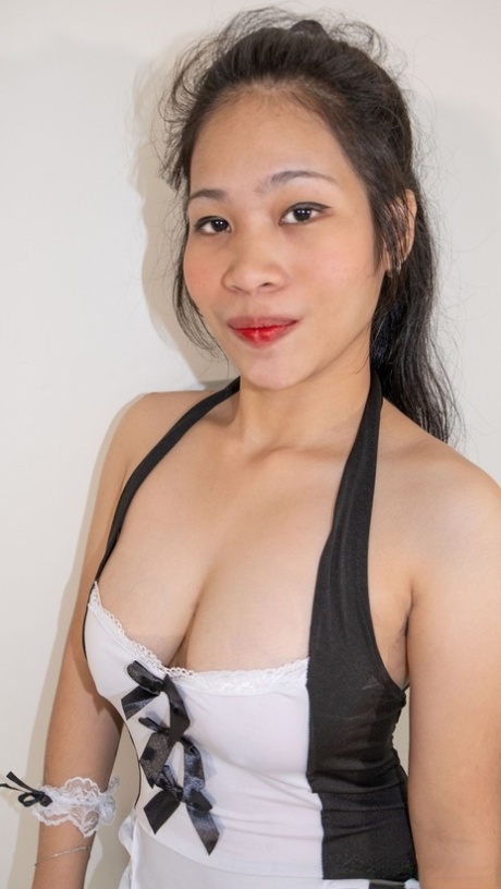 Chubby Asian maid Queenie posing and unleashing her big boobs in a solo