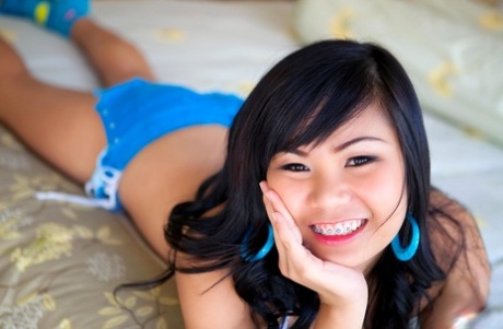 Chubby Asian sexpot Poy takes off her bikini & spreads her inviting pussy