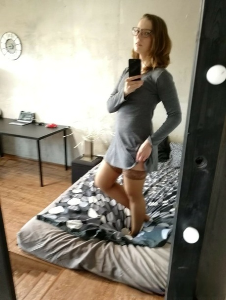 Naughty amateur nerd poses naked in her bedroom while home alone