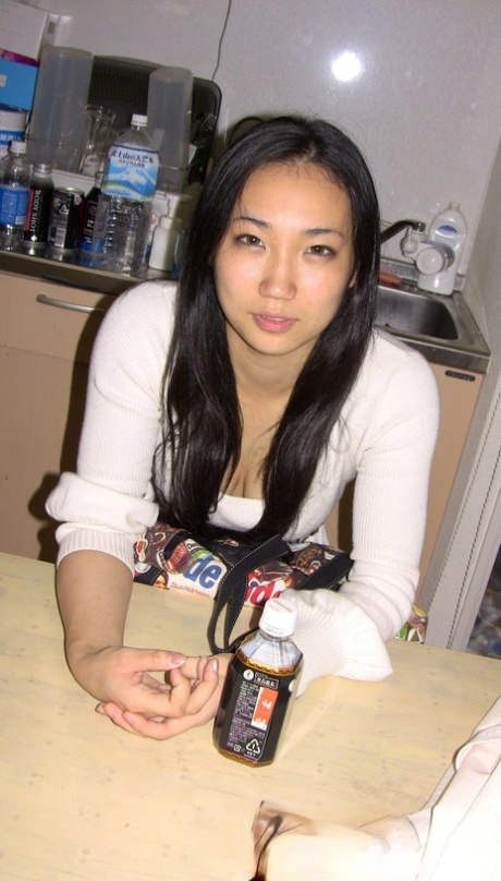 Sexy Asian babe unveils her wonderful breasts and her trimmed bush