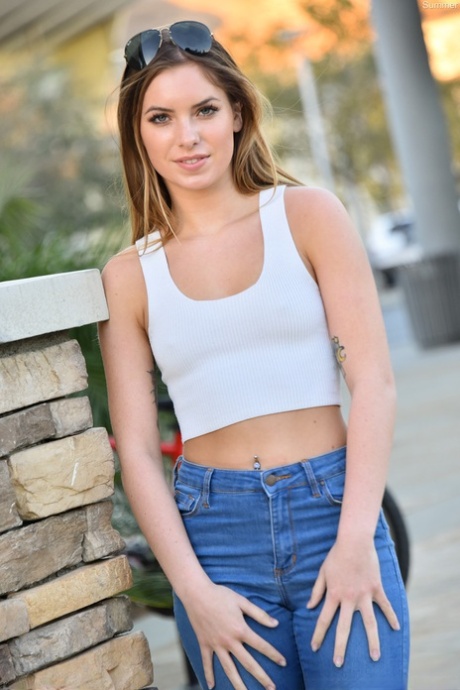 Sexy babe Summer shows her tiny tits while teasing in a jeans outfit outdoors