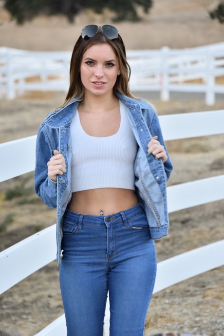 Sexy babe Summer shows her tiny tits while teasing in a jeans outfit outdoors