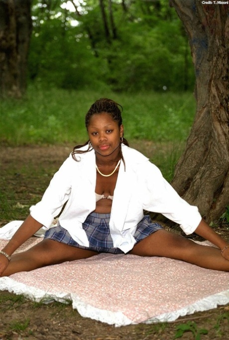 Pretty ebony schoolgirl Lorna shows her tits & her trimmed pussy outdoors