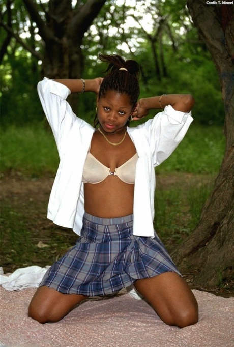 Pretty ebony schoolgirl Lorna shows her tits & her trimmed pussy outdoors