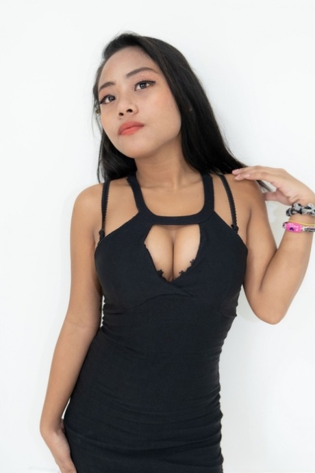Sexy Asian hooker Joylyn strips her dress & lingerie & poses naked