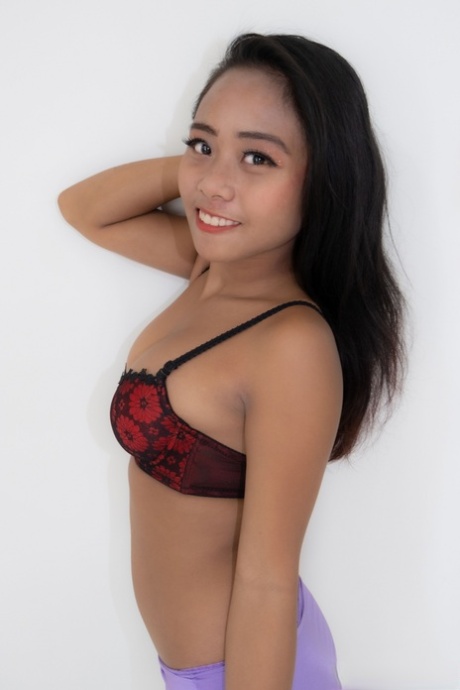 Sexy Asian hooker Joylyn strips her dress & lingerie & poses naked