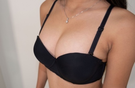Brunette Asian babe Rebecca strips off her bra & shows her hot perky tits