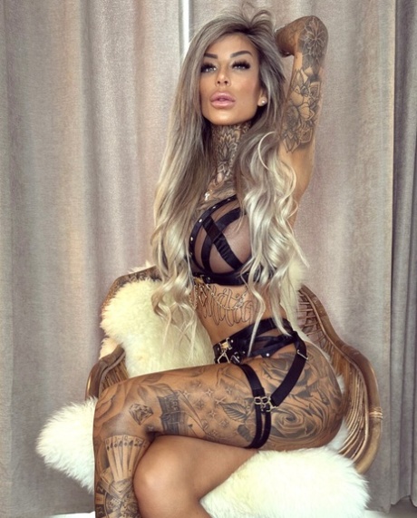 Big-breasted glamour babe shows off her stunning tattoos in strappy lingerie