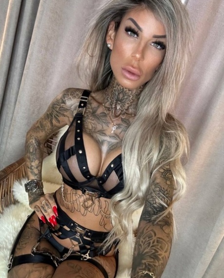Big-breasted glamour babe shows off her stunning tattoos in strappy lingerie
