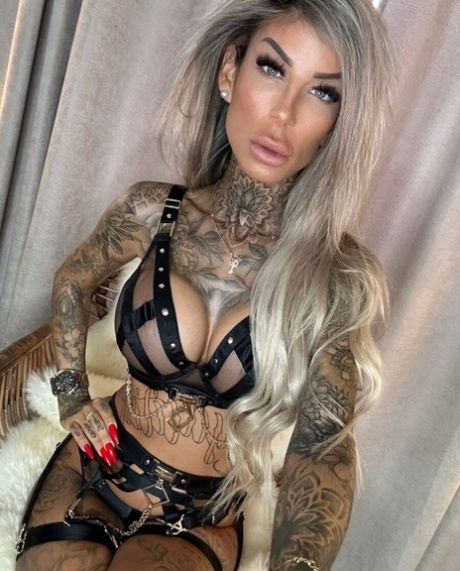 Big-breasted glamour babe shows off her stunning tattoos in strappy lingerie