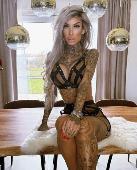 Big-breasted glamour babe shows off her stunning tattoos in strappy lingerie