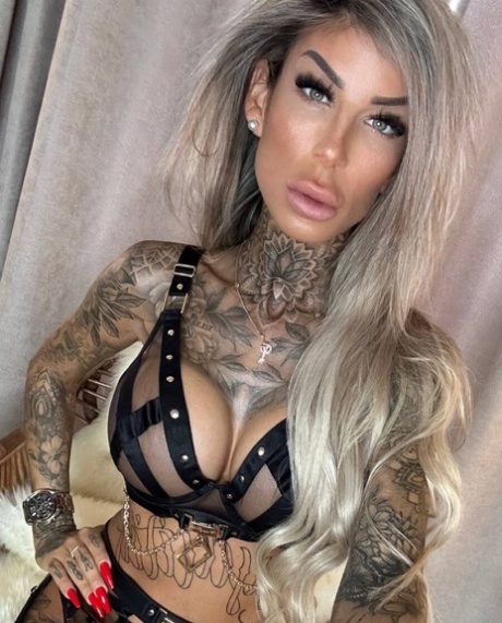 Big-breasted glamour babe shows off her stunning tattoos in strappy lingerie