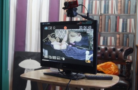 Curly-haired beauty poses nude & in a short dress in a behind the scenes solo