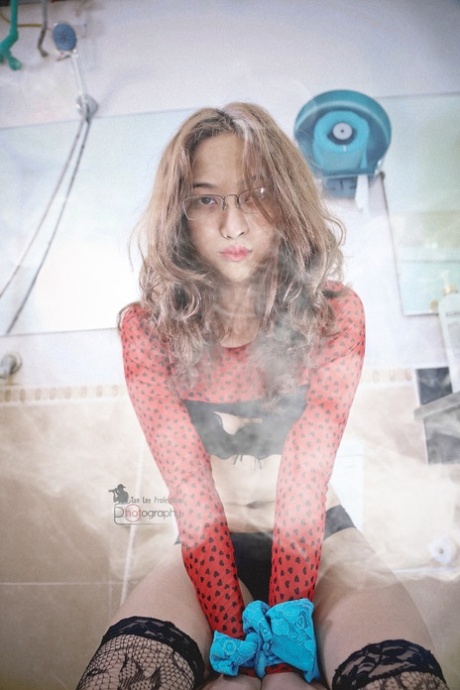 Dark-haired Asian hottie with eyeglasses poses in her sexy lingerie