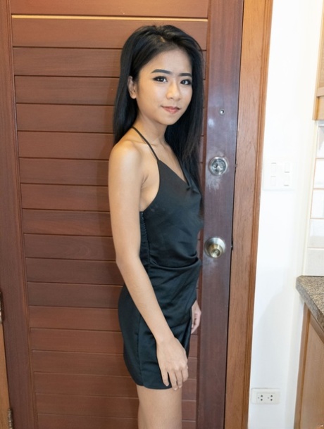 Pretty Asian babe Som bares her lovely tits in a hot tease in fetish wear