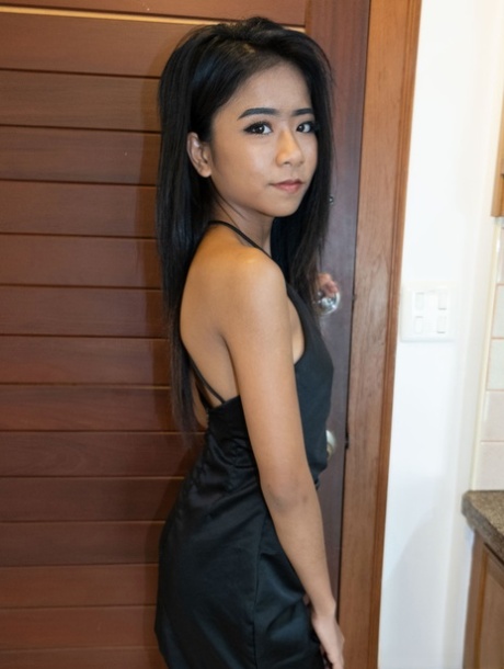 Pretty Asian babe Som bares her lovely tits in a hot tease in fetish wear