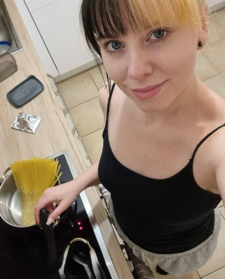 Hot amateur babe Kirajameson shows off her curves while cooking in the kitchen