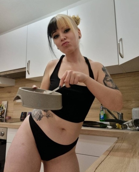 Hot amateur babe Kirajameson shows off her curves while cooking in the kitchen