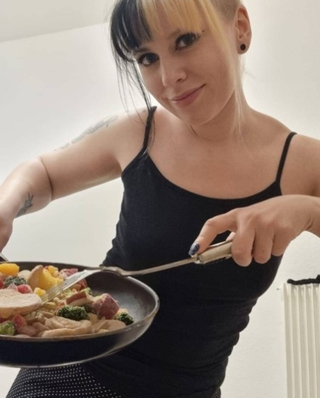 Hot amateur babe Kirajameson shows off her curves while cooking in the kitchen