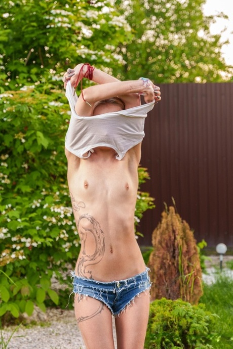 Slender European teen Tea Mint flaunts her tiny tits and masturbates outdoors