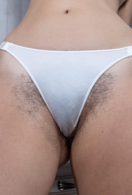 Tall brunette Stephaniya strips her dress & panties to show her hairy twat