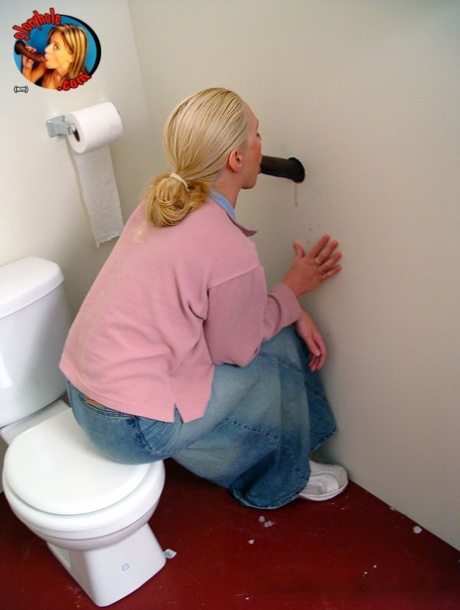 Blonde girl Jamie sits on the toilet and blows a black gloryhole dong