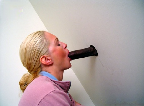 Blonde girl Jamie sits on the toilet and blows a black gloryhole dong