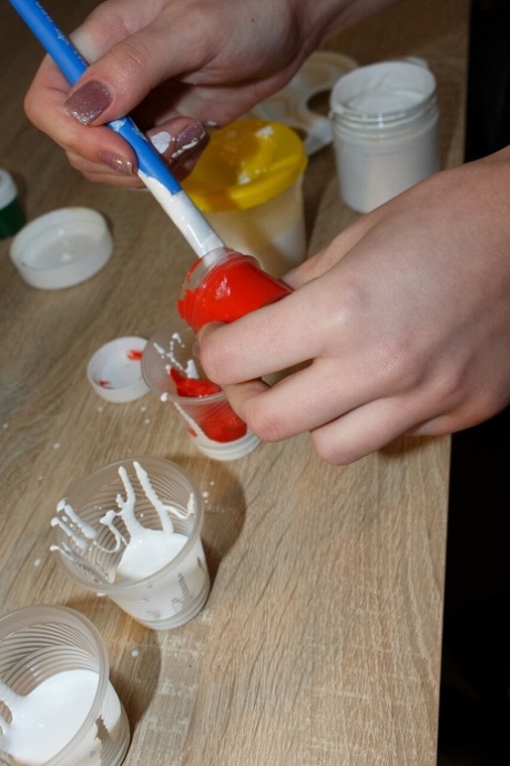 Pretty artist Kristina Proxy plays with her paints while totally naked
